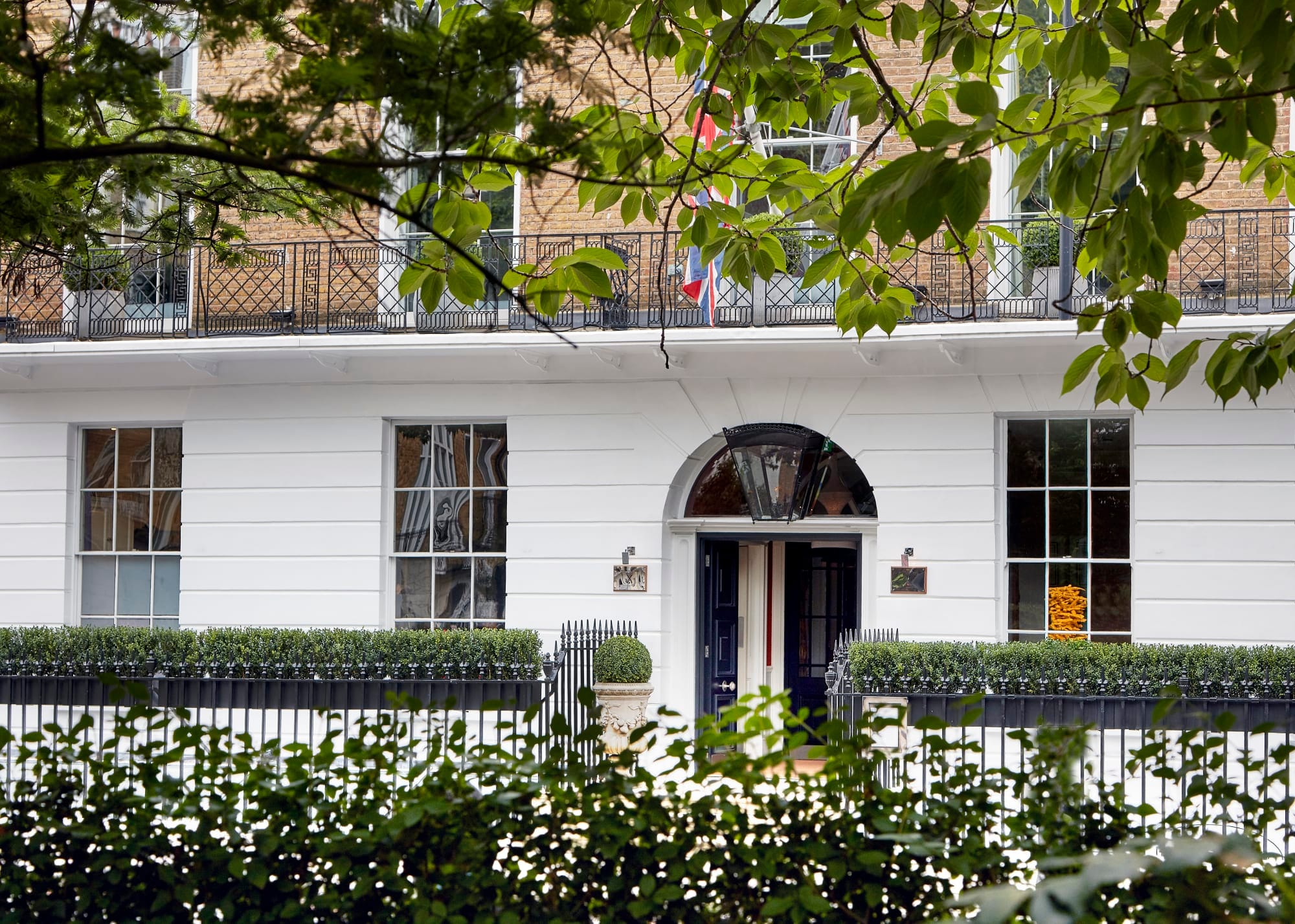 Dorset Square Hotel seen through the trees of the garden square opposite, on a quiet Marylebone terrace