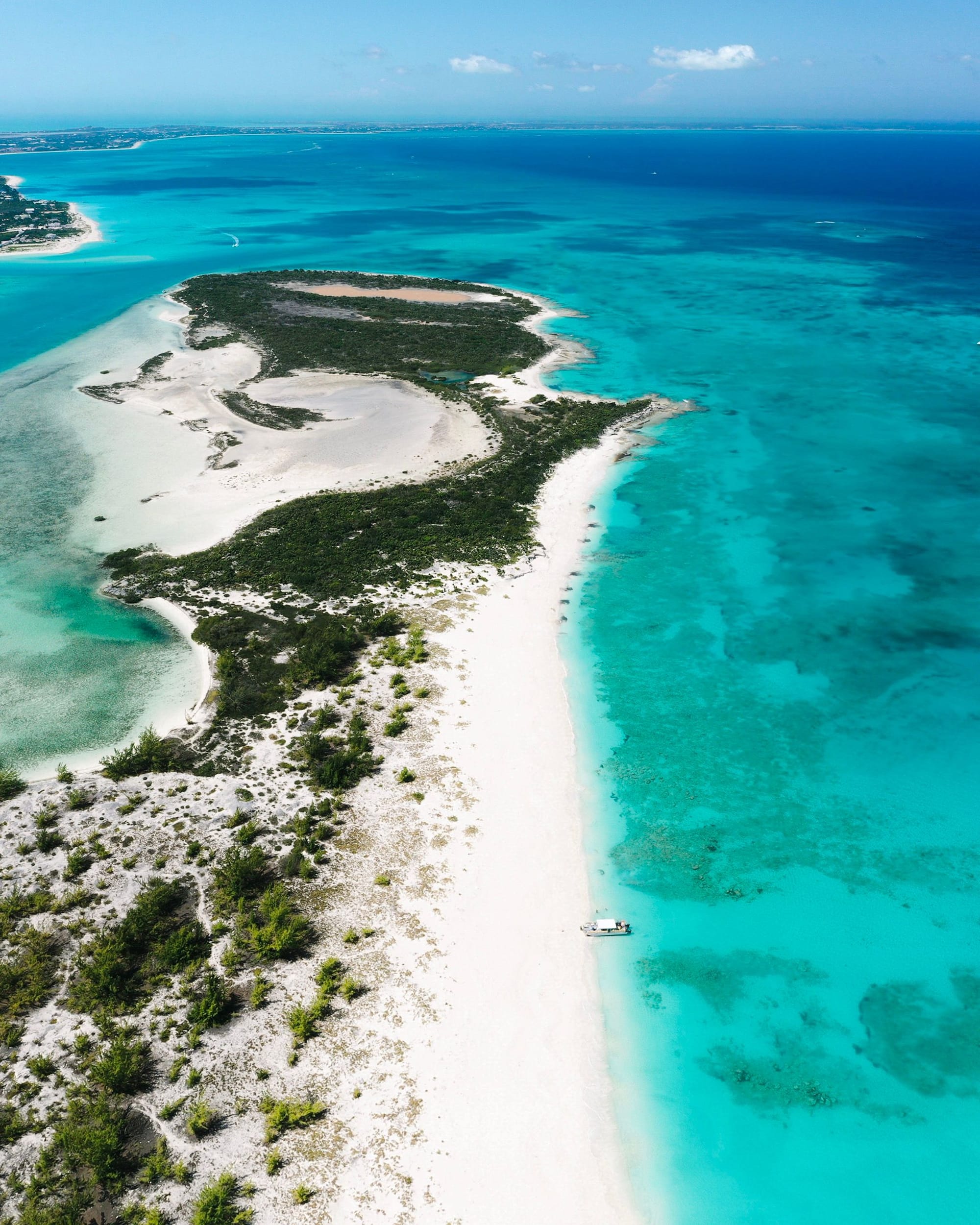 Aerial view of a Turks and Caicos beach where white sand meets turquoise water